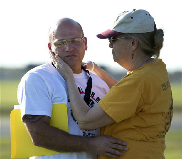 Miriam Wiley Elliott, right, comforts Seth Penalver, prior to the execution of Robert L. Henry, by the prison near Starke. Henry received a lethal injection last week for the murders of Phyllis Harris, 53, and Janet Thermidor, 35. Photo- AP
Miriam Wiley Elliott, right, comforts Seth Penalver, prior to the execution of Robert L. Henry, by the prison near Starke. Henry received a lethal injection last week for the murders of Phyllis Harris, 53, and Janet Thermidor, 35. Photo- AP